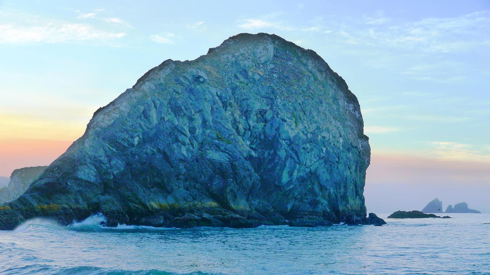 A large rock sea stack rising from the ocean at Harris Beach State Park near Brookings