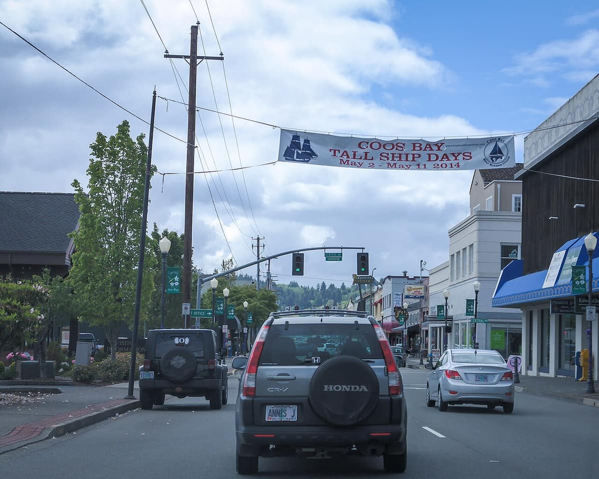 Central Avenue in downtown Coos Bay with a banner strung across the street