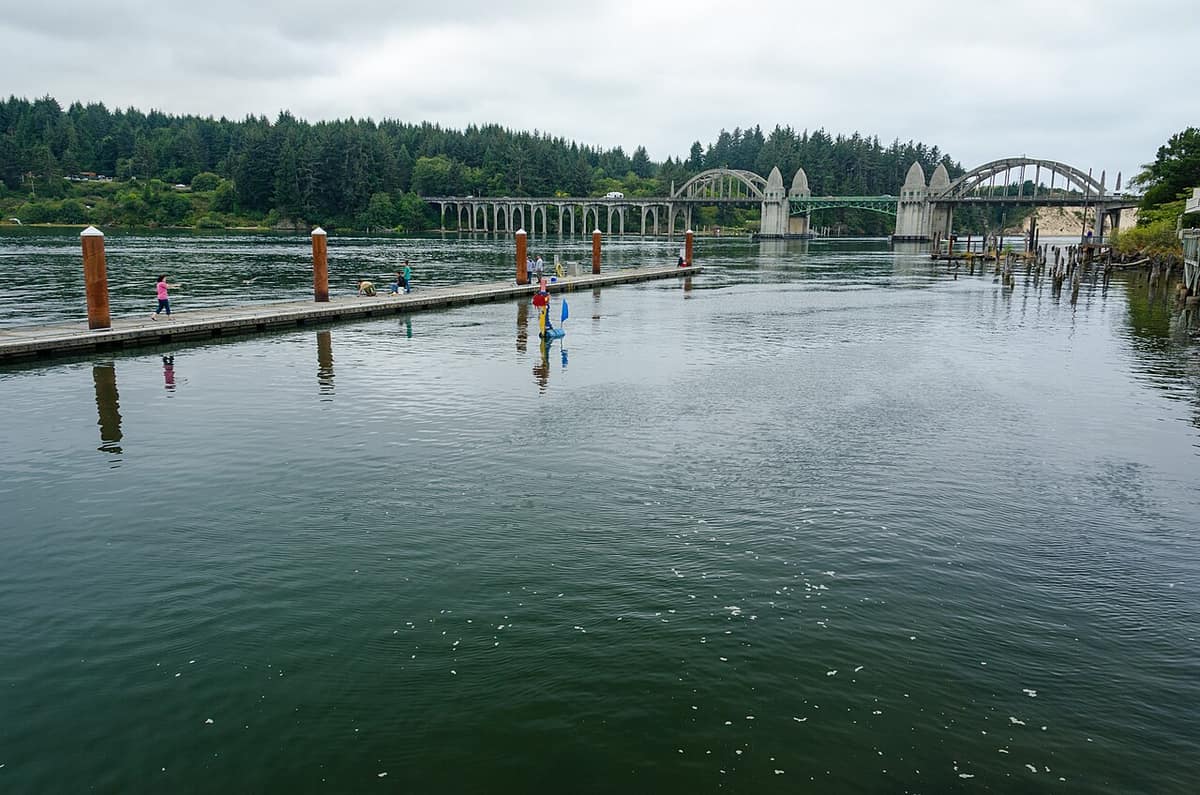 public dock on the Siuslaw River at the Florence waterfront with the Siuslaw River Bridge beyond