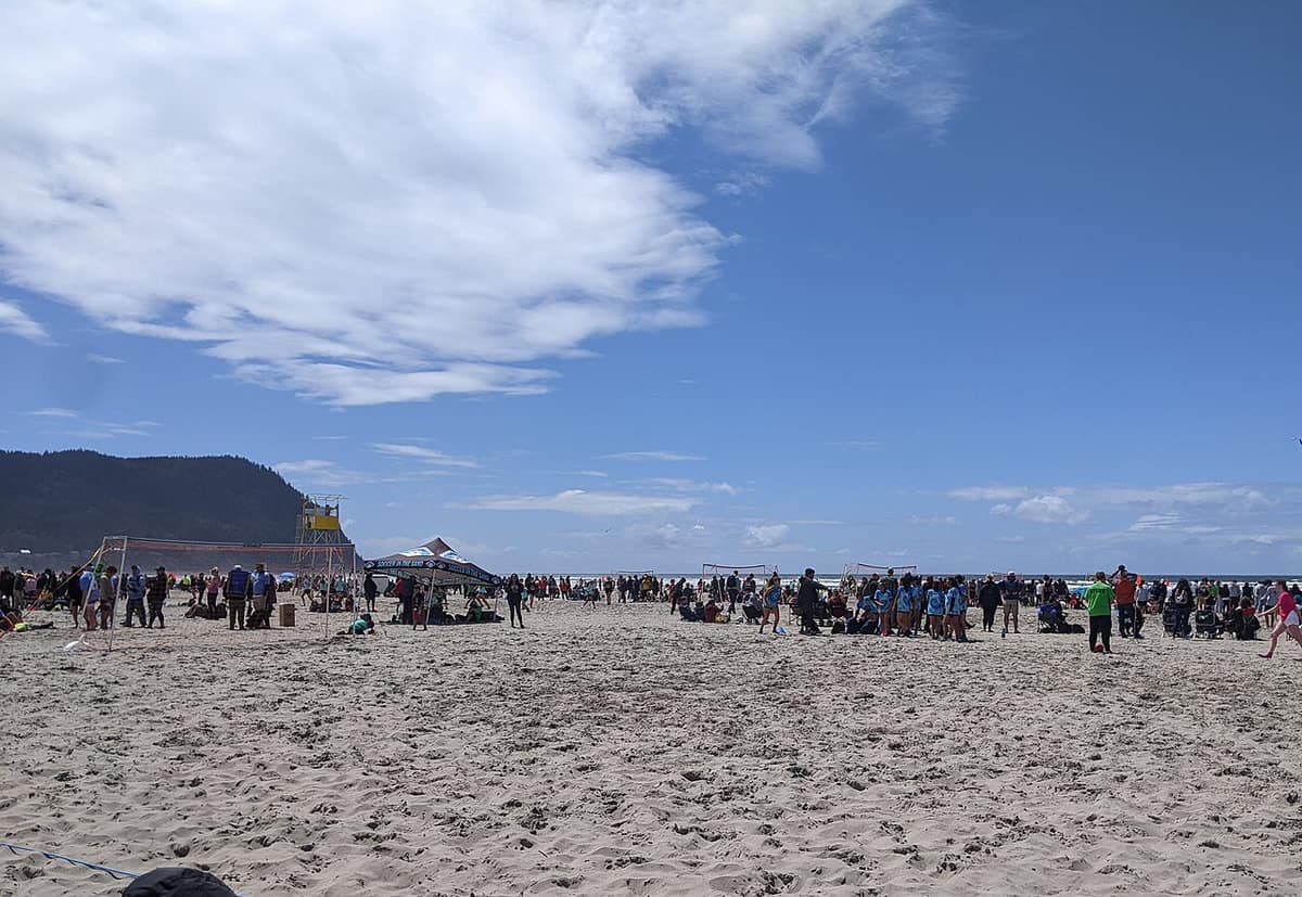 Crowds at a sand soccer and volleyball tournament on the beach at Seaside, Oregon